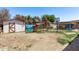 This backyard features a playset, storage shed, basketball hoop, and lush trees at 6814 W Berkeley Rd, Phoenix, AZ 85035