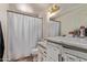 This charming bathroom features a shower and vanity with marble countertops at 6814 W Berkeley Rd, Phoenix, AZ 85035