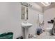 Small bathroom featuring a white pedestal sink, mirror, and toilet at 6814 W Berkeley Rd, Phoenix, AZ 85035