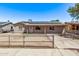 Single-story home featuring solar panels, fenced front yard, neutral paint, and covered entry at 6814 W Berkeley Rd, Phoenix, AZ 85035
