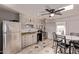 Bright kitchen with ample cabinetry, modern appliances, tile floors, and adjacent dining area at 6814 W Berkeley Rd, Phoenix, AZ 85035