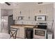 Galley kitchen featuring wooden cabinets, stainless steel appliances, and a double-basin sink at 6814 W Berkeley Rd, Phoenix, AZ 85035