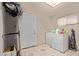 This laundry room features tile floors, a utility sink and a washer/dryer at 6814 W Berkeley Rd, Phoenix, AZ 85035