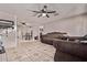 Open-concept living and dining area featuring decorative tile flooring, sofas, and ceiling fan at 6814 W Berkeley Rd, Phoenix, AZ 85035