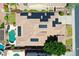 Aerial view of a house with a solar panels, swimming pool and nicely landscaped yard at 6886 W Mazatzal Dr, Peoria, AZ 85383