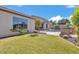 Landscaped backyard featuring a barbecue, a swimming pool, and lush greenery at 6886 W Mazatzal Dr, Peoria, AZ 85383