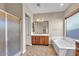 Bathroom featuring a shower, bathtub, and wood vanity at 6886 W Mazatzal Dr, Peoria, AZ 85383