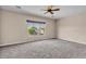 Serene bedroom with plush carpet, ceiling fan, and a bright window at 6886 W Mazatzal Dr, Peoria, AZ 85383