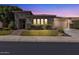 Charming single-story home featuring desert landscaping, stone accents, and a two-car garage at twilight at 6886 W Mazatzal Dr, Peoria, AZ 85383