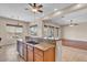 Modern kitchen featuring an island with granite countertops, stainless steel appliances, and open layout to the living areas at 6886 W Mazatzal Dr, Peoria, AZ 85383