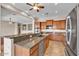 Open kitchen boasts an island with granite countertops, stainless steel appliances, and ample cabinet space at 6886 W Mazatzal Dr, Peoria, AZ 85383