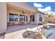 Charming patio area with outdoor seating, a ceiling fan, and access to the pool and backyard at 6886 W Mazatzal Dr, Peoria, AZ 85383
