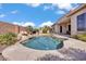 Resort-like pool featuring a rock waterfall, desert landscaping and a built-in BBQ at 6886 W Mazatzal Dr, Peoria, AZ 85383