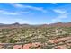 Scenic aerial view showing a desert community and golf course with beautiful mountain views at 7134 E Sandia St, Mesa, AZ 85207