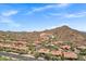 Expansive aerial view showcasing the community with mature landscaping, red tile roofs and mountain views at 7134 E Sandia St, Mesa, AZ 85207