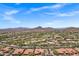 Wide aerial shot of the desert community showing the red tiled roofs and golf course with mountain backdrop at 7134 E Sandia St, Mesa, AZ 85207