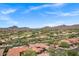 Panoramic aerial shot of the neighborhood with a golf course, desert landscaping, and mountain views at 7134 E Sandia St, Mesa, AZ 85207