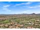 Picturesque aerial view featuring a community, golf course, and desert landscape with distant mountain scenery at 7134 E Sandia St, Mesa, AZ 85207