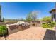 Outdoor BBQ area and fireplace on brick-paved patio with desert landscape at 7134 E Sandia St, Mesa, AZ 85207