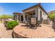 Stylish backyard patio with outdoor dining set and desert landscape at 7134 E Sandia St, Mesa, AZ 85207