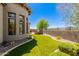 Beautiful backyard with manicured lawn, desert landscaping, and an outdoor living space at 7134 E Sandia St, Mesa, AZ 85207