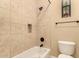 Bright bathroom featuring a tiled shower and a toilet at 7134 E Sandia St, Mesa, AZ 85207