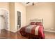 Comfortable bedroom featuring hardwood floors and ensuite bathroom access at 7134 E Sandia St, Mesa, AZ 85207