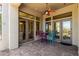 Covered patio with colorful furniture and multiple glass doors at 7134 E Sandia St, Mesa, AZ 85207