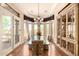 Elegant dining room with a glass table, custom cabinetry, and a tray ceiling at 7134 E Sandia St, Mesa, AZ 85207