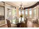 Bright dining area featuring a glass table, decorative chandelier, and ample natural light at 7134 E Sandia St, Mesa, AZ 85207