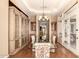 Elegant dining room boasts a glass table, decorative chandelier, and custom cabinetry at 7134 E Sandia St, Mesa, AZ 85207