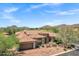 Stunning stone home with a red tile roof, mature trees, and mountain views, offers privacy and curb appeal at 7134 E Sandia St, Mesa, AZ 85207