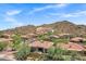 Desert community home featuring desert landscaping, a red tile roof, neutral stucco, and mountain views at 7134 E Sandia St, Mesa, AZ 85207