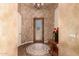 Grand foyer featuring beautiful floors, decorative lighting, and a striking front door at 7134 E Sandia St, Mesa, AZ 85207