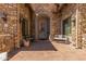 Inviting front entrance featuring beautiful stone work and a cozy sitting area at 7134 E Sandia St, Mesa, AZ 85207