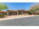 Charming stone home featuring a tile roof, two-car garage, and beautiful landscaping at 7134 E Sandia St, Mesa, AZ 85207