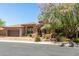 Charming stone home featuring a tile roof, two-car garage, and beautiful landscaping at 7134 E Sandia St, Mesa, AZ 85207
