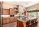 Gourmet kitchen featuring custom cabinets, a granite island, and high-end stainless steel appliances at 7134 E Sandia St, Mesa, AZ 85207