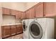 Bright laundry room with sink, cabinets, and washer/dryer at 7134 E Sandia St, Mesa, AZ 85207