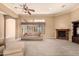 Relaxing living space boasting plush carpets, fireplace, and natural light at 7134 E Sandia St, Mesa, AZ 85207