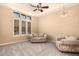 Bright living room with neutral walls, plush carpet, and a modern ceiling fan at 7134 E Sandia St, Mesa, AZ 85207