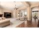 Spacious living area with plush seating, tile entryway, and seamless flow to dining at 7134 E Sandia St, Mesa, AZ 85207