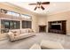 Cozy living room featuring a corner fireplace, custom built-ins, and plush seating at 7134 E Sandia St, Mesa, AZ 85207