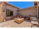 Charming outdoor patio with seating, decorative stone, and fire pit at 7134 E Sandia St, Mesa, AZ 85207
