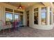 Covered patio featuring colorful seating, decorative fan, and doors leading inside at 7134 E Sandia St, Mesa, AZ 85207