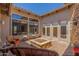 Spacious patio featuring a fire pit, stone accents and comfortable seating at 7134 E Sandia St, Mesa, AZ 85207