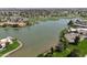An aerial shot showcases a lake with a golf course nearby and houses with green landscaping at 7214 E Royal Palm Rd, Scottsdale, AZ 85258