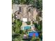 Aerial view of the estate featuring a pool, spa, basketball court, and manicured lawns at 7214 E Royal Palm Rd, Scottsdale, AZ 85258