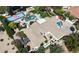 An aerial view of a house with multiple amenities including swimming pool, a sport court, and well manicured greenery at 7214 E Royal Palm Rd, Scottsdale, AZ 85258