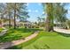 Expansive backyard featuring lush lawn, mature trees, and inviting outdoor amenities at 7214 E Royal Palm Rd, Scottsdale, AZ 85258